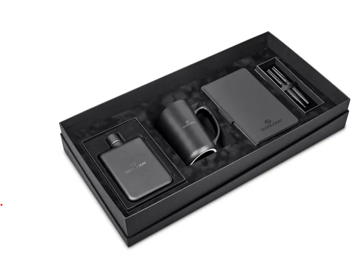 Black premium gift set in a rectangular presentation box, featuring a slim flask, a matte black mug, a notebook, and a pen arranged in custom foam compartments.