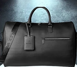 **Alt text:** A sleek black leather duffel bag with handles and a shoulder strap, featuring a matching luggage tag, displayed against a textured dark background for a premium, professional look.